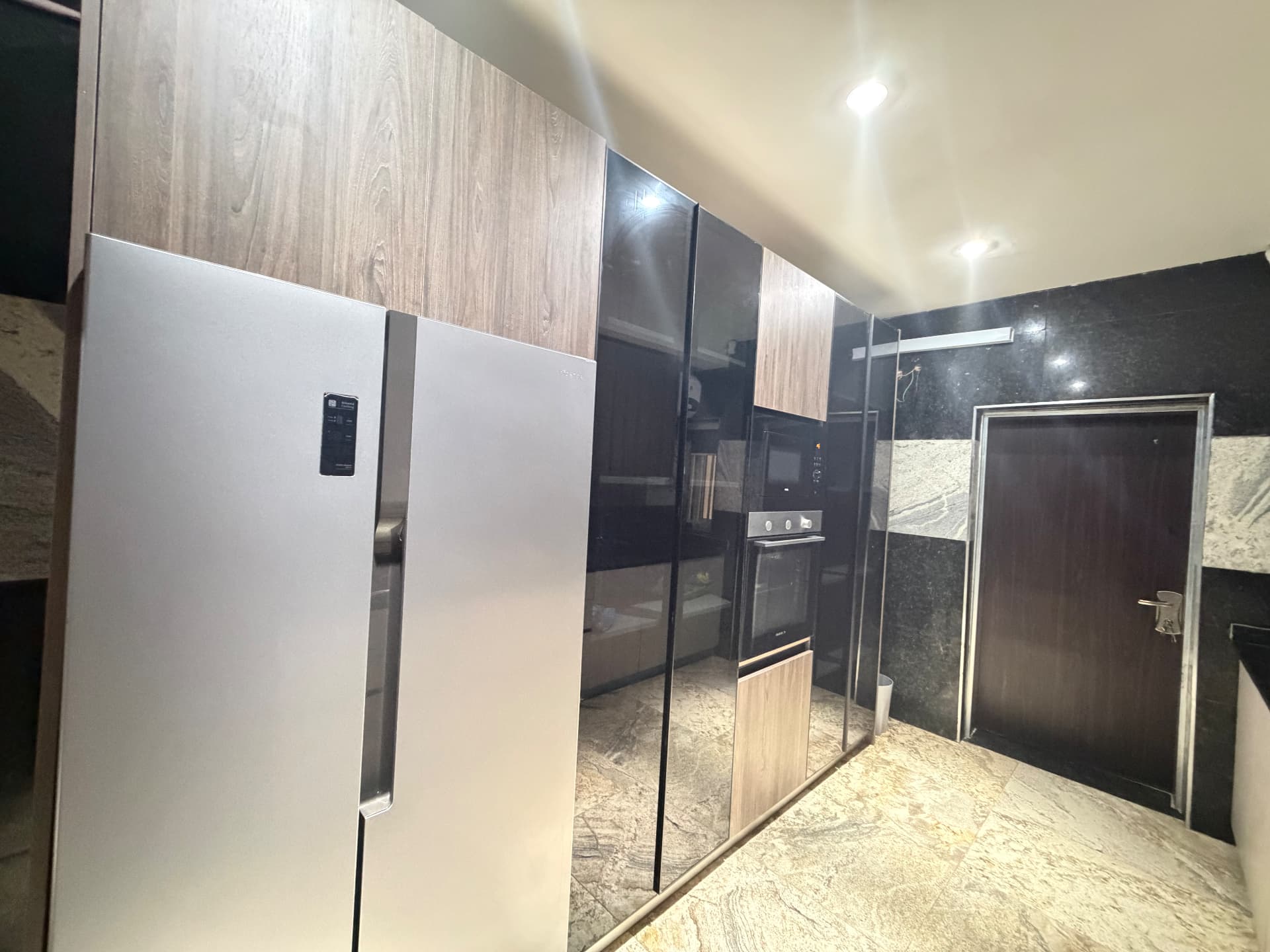 Fitted kitchen with fridge freezer, oven, microwave and cabinetry