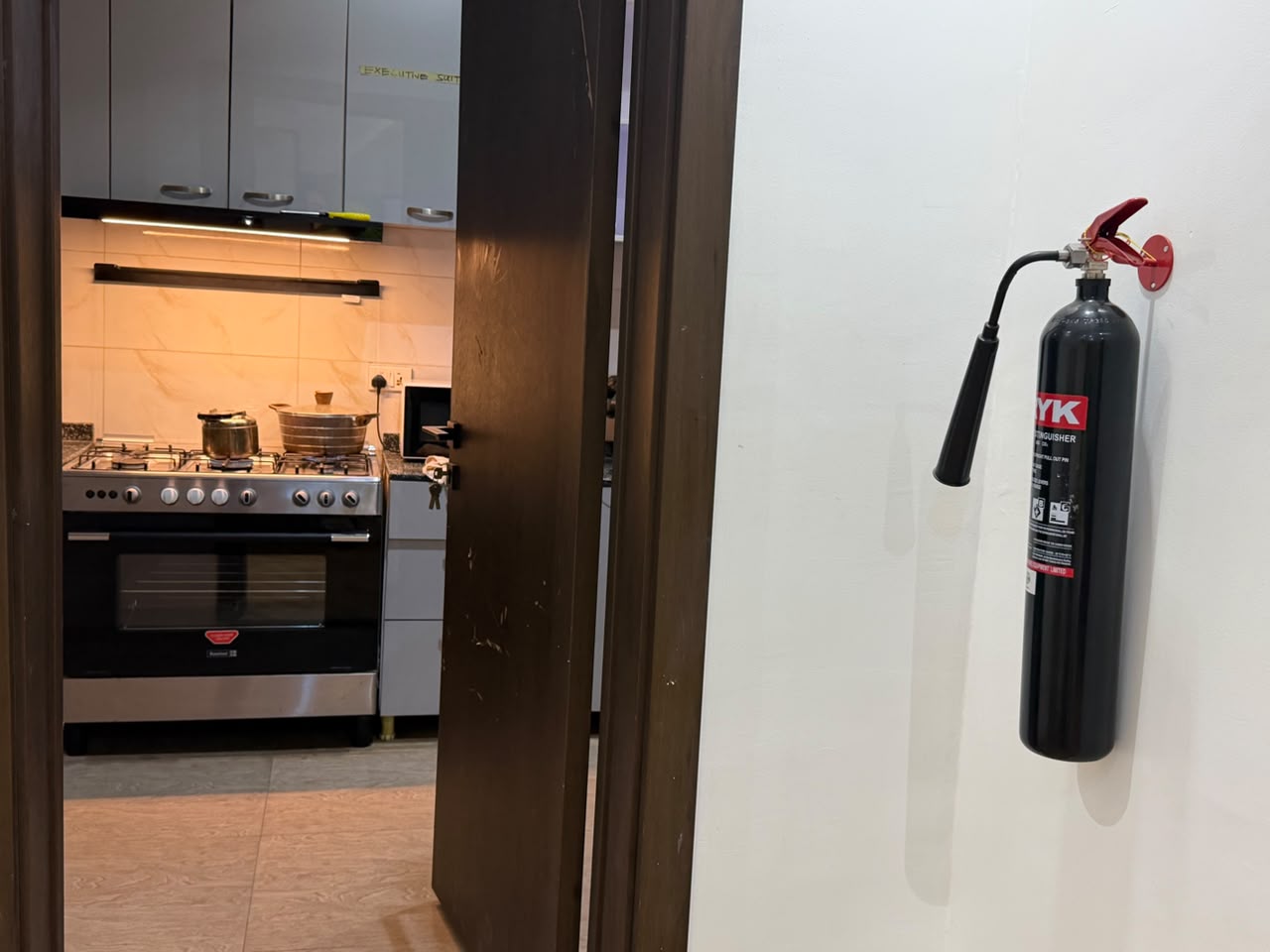 Shared kitchen of the Aston residence with a gas range cooker, microwave and fitted cabinets