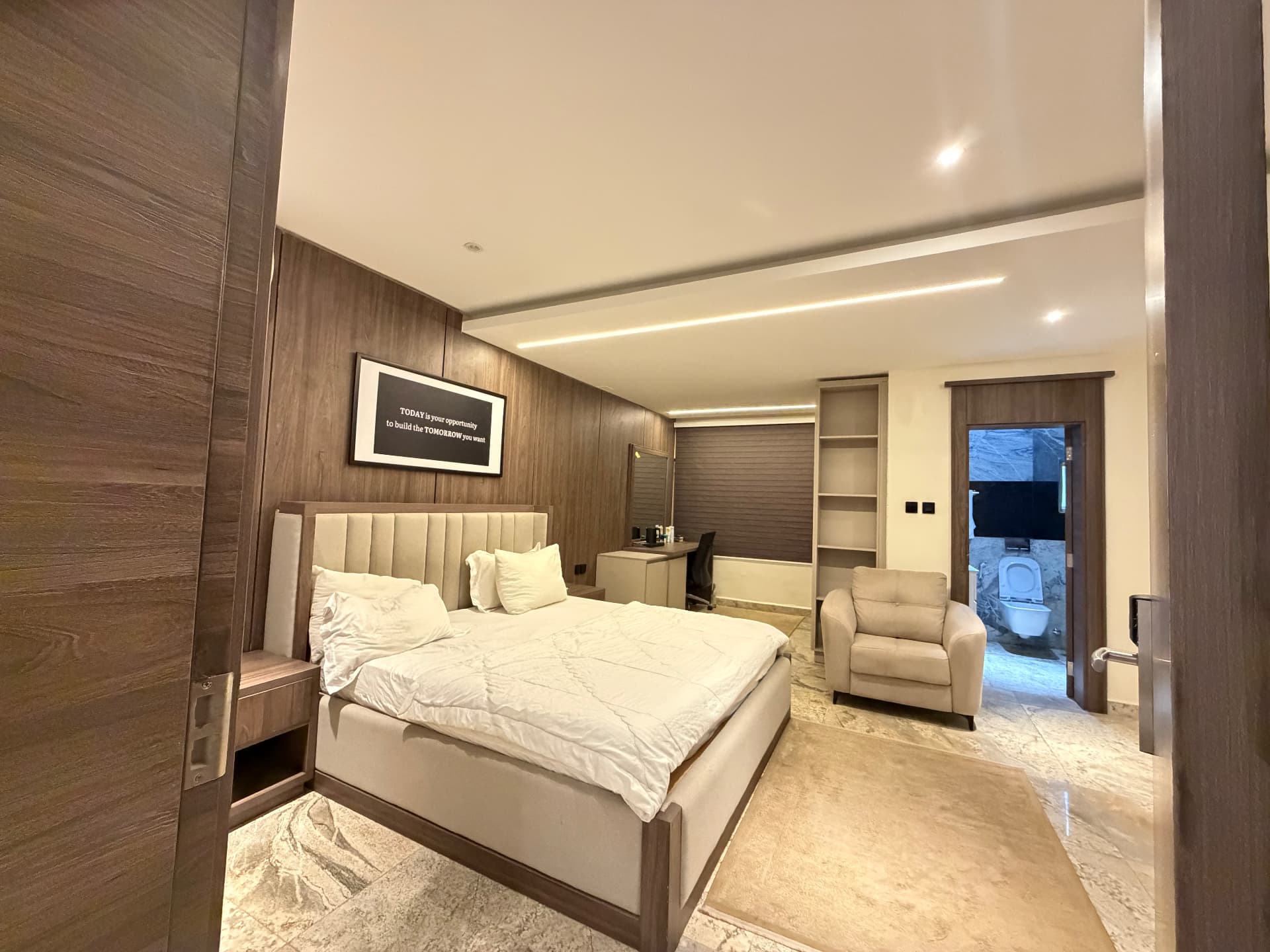 Private bedroom with a double bed, fitted wardrobes, desk and adjoining bathroom