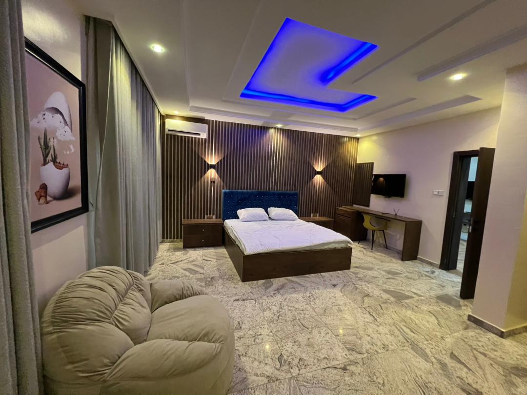Presidential Suite showing the work desk, chair, wall-mounted television and framed artwork