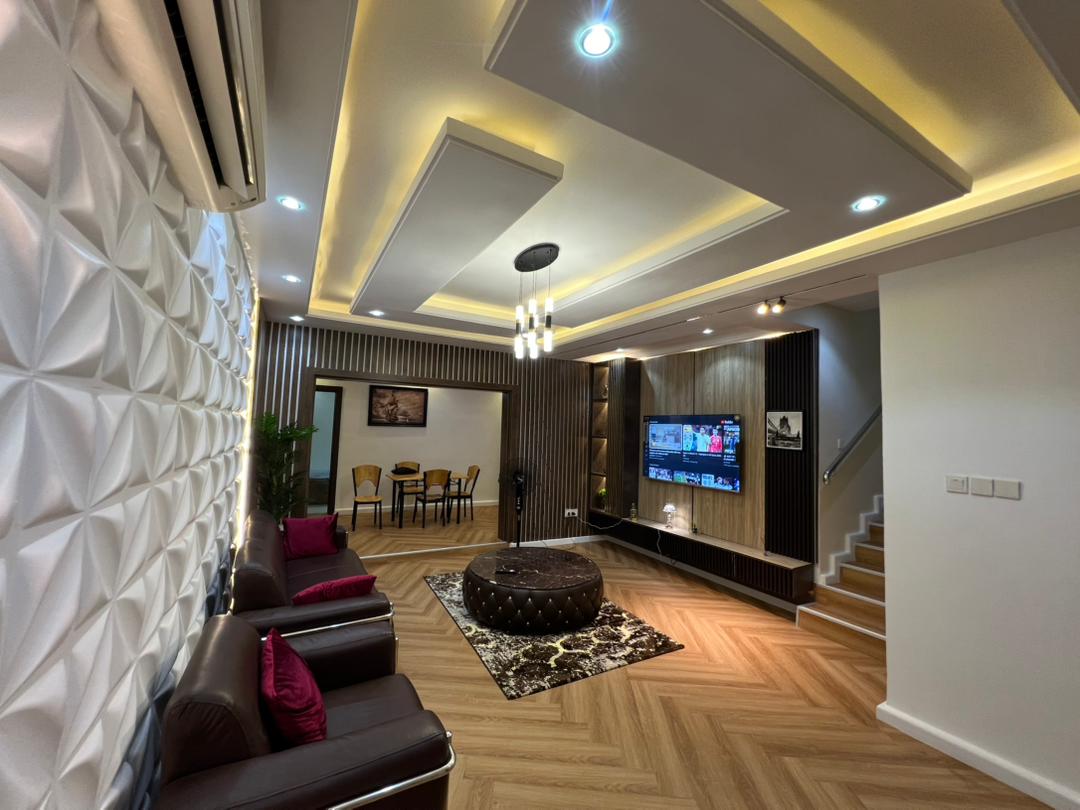 Shared living room of the Aston shared residence with sofas, television and dining area beyond