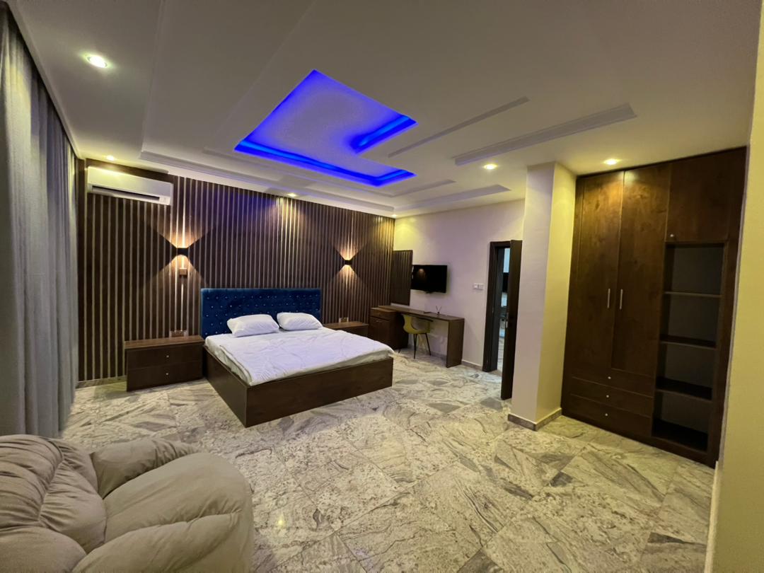 Presidential Suite sleeping area with double bed, bedside drawers, air conditioning and fitted wardrobe